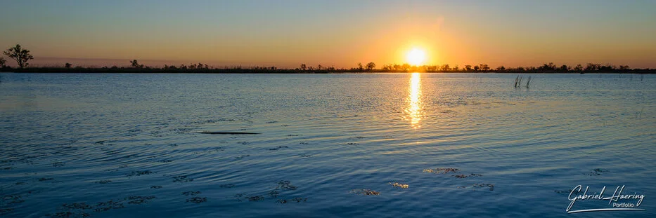 Sunset over open water in the Okavango Delta, Botswana