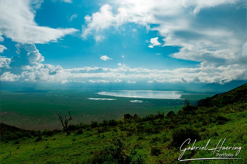 Wide view over Ngorongoro Crater with dramatic clouds and lake, Tanzania photographic safari landscape
