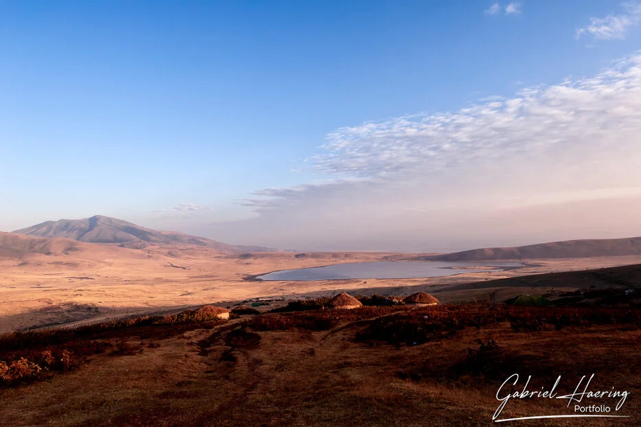 Ngorongoro Crater landscape at golden light with lake and volcanic slopes, Tanzania wildlife photography