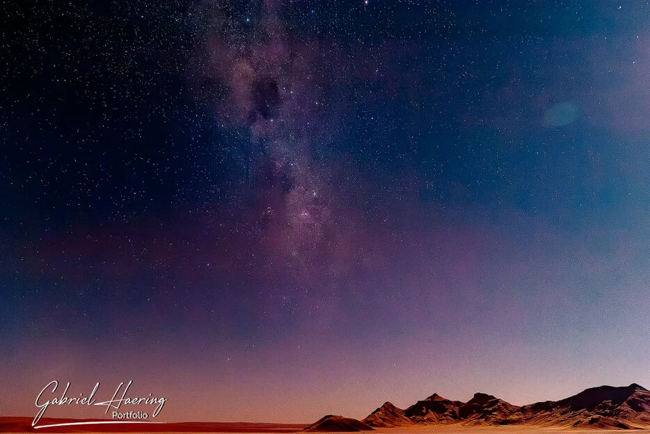 Starry night sky and Milky Way above desert mountains in the Namib-Naukluft region of Namibia